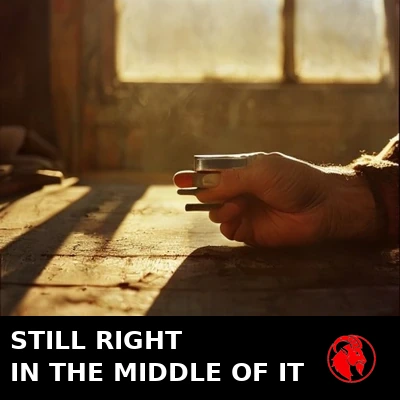 A weathered hand holding a single bolt over a cluttered workbench in golden light. Caption: Still right in the middle of it
