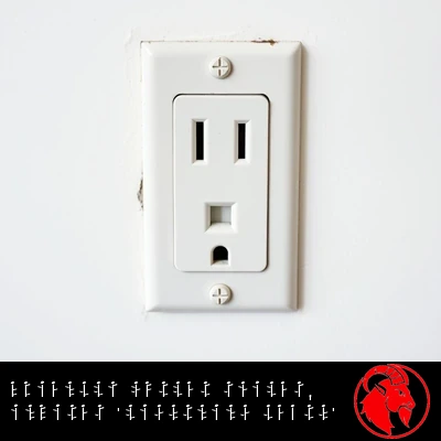 A single-receptacle US electrical wall outlet whose slots and ground hole resemble a friendly smiling face. Caption: Friendly outlet smiles, invites 'Lightning Death'.